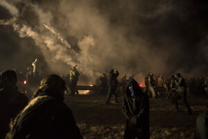 Law enforcement releases tear gas to disperse the crowd of nonviolent water protectors gathered at the barricade to the construction of the Dakota Access oil pipeline  on Nov. 20. The United States Army Corps of Engineers rejected the pipeline to be built under Lake Oahe, a Missouri River reservoir on Sunday. 